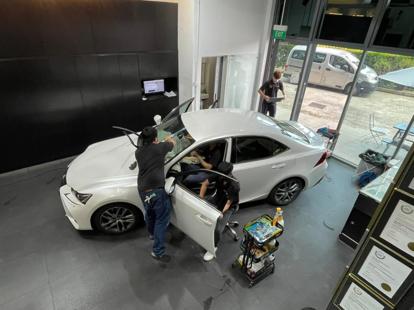 Overhead view of a white Lexus IS being tinted by the team at Infratint Singapore