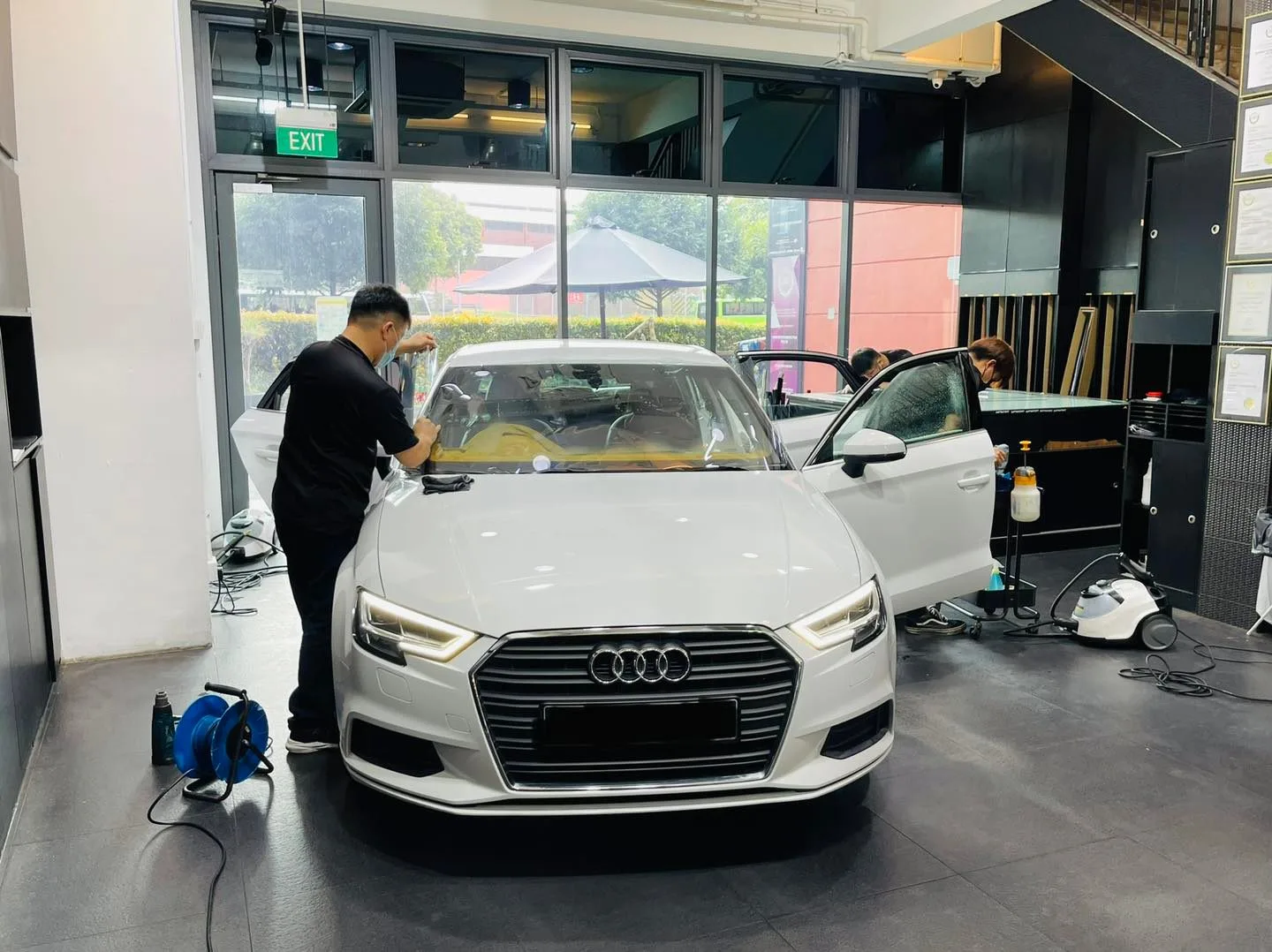 White Audi sedan having its windscreen tinted at Infratint Singapore