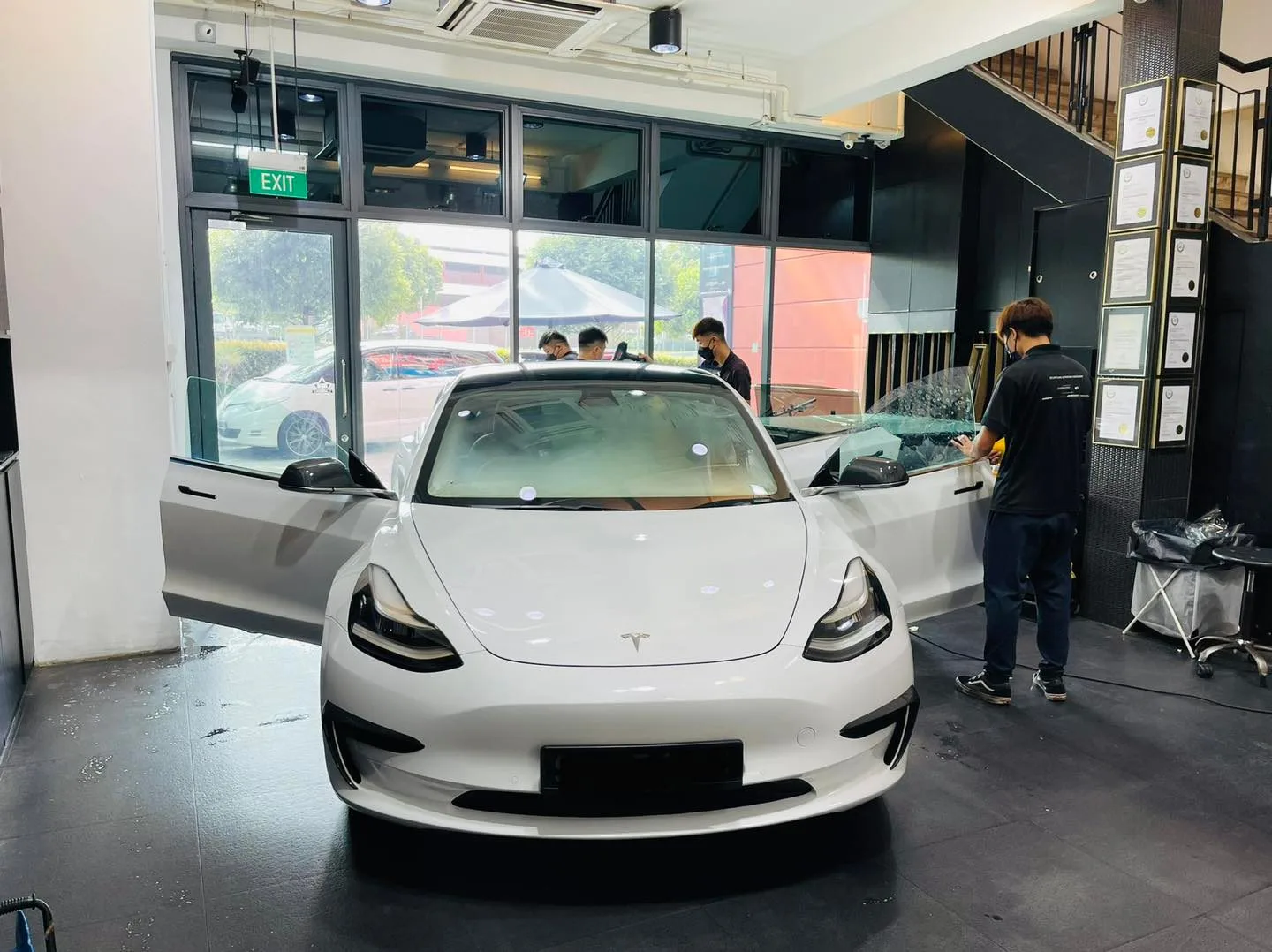 White Tesla Model 3 during window film installation at Infratint Singapore