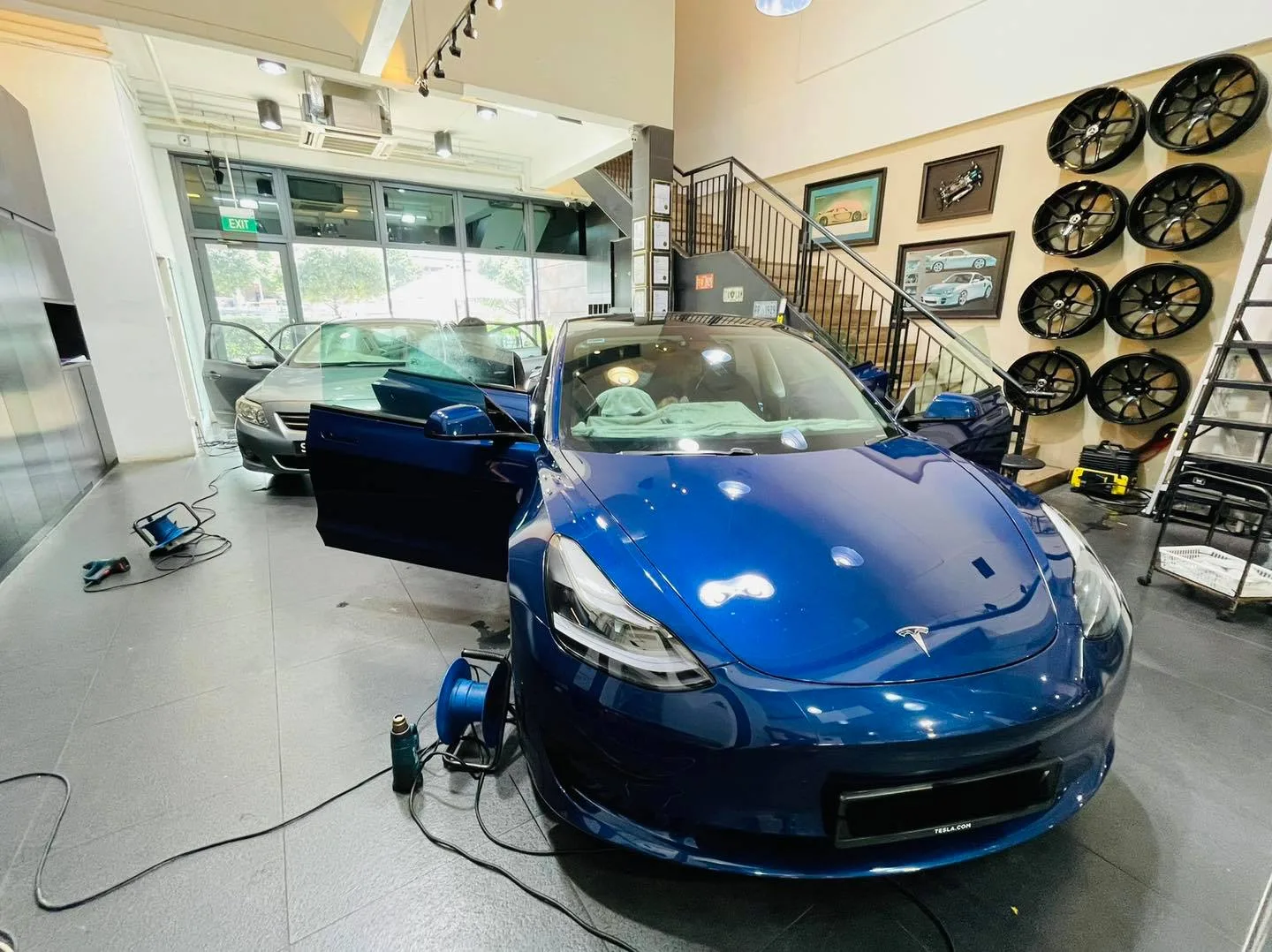 Blue Tesla Model 3 during window tinting at Infratint Singapore