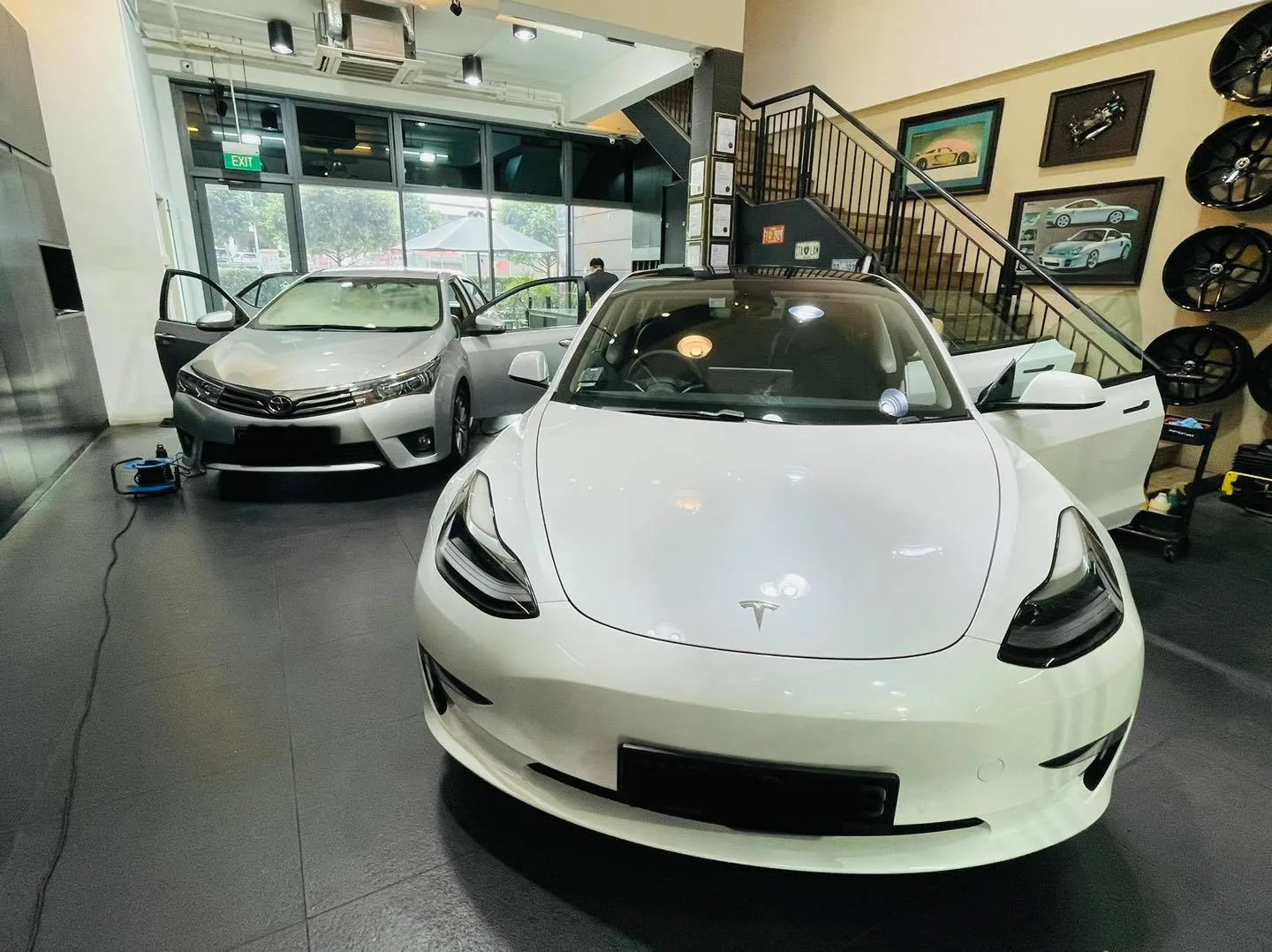 White Tesla Model 3 and silver Toyota Corolla Altis at Infratint Singapore for window tinting