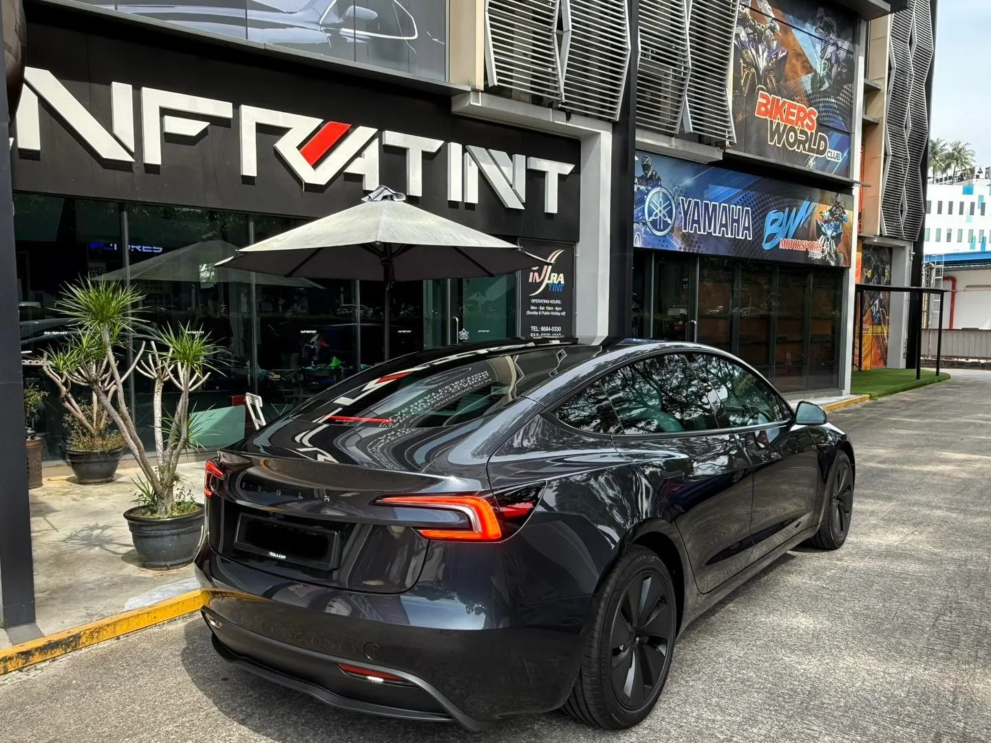 Tesla Model 3 Highland rear three-quarter view with tinted glass and tail light bar at Infratint Singapore