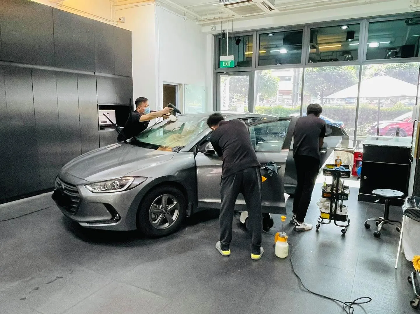 Grey Hyundai Elantra during window film install at Infratint Singapore