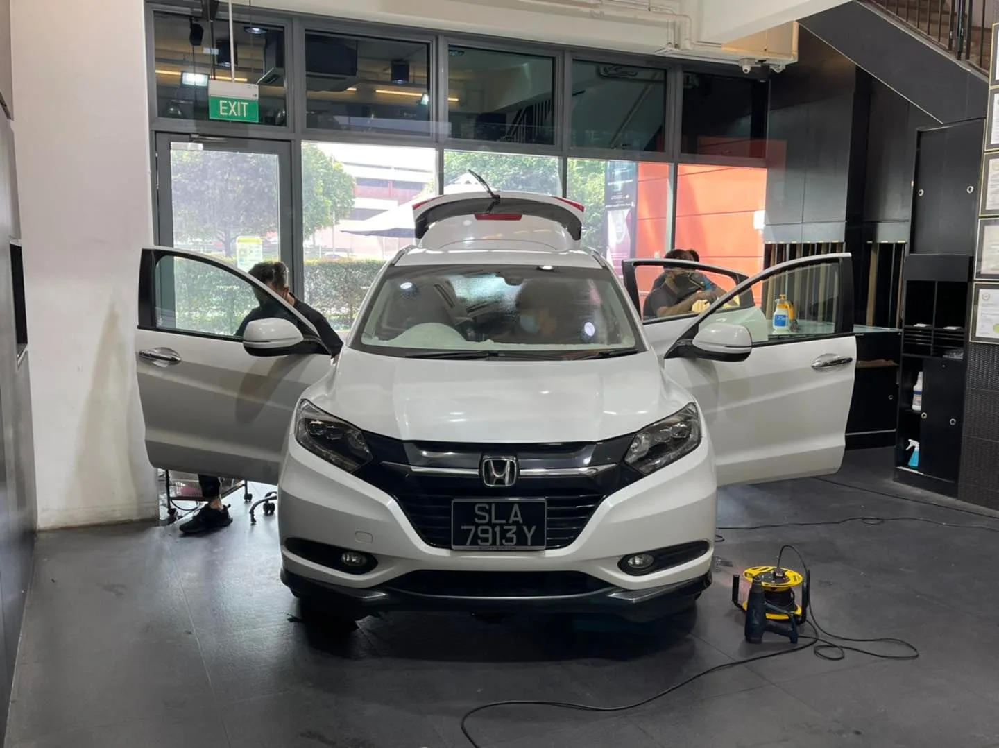 White Honda HR-V front view with doors open during window tinting at Infratint Singapore