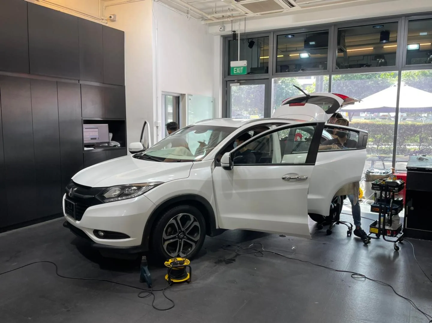 White Honda HR-V with tailgate open during window film install at Infratint Singapore