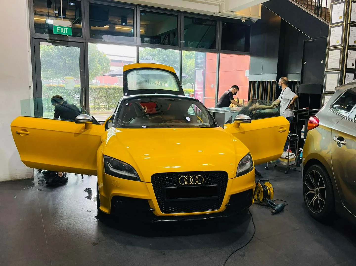 Yellow Audi TT with doors open during window tinting at Infratint Singapore