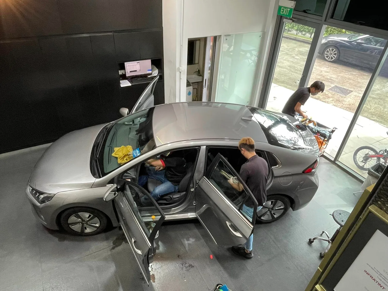Overhead view of a silver Hyundai Ioniq being window tinted at Infratint Singapore