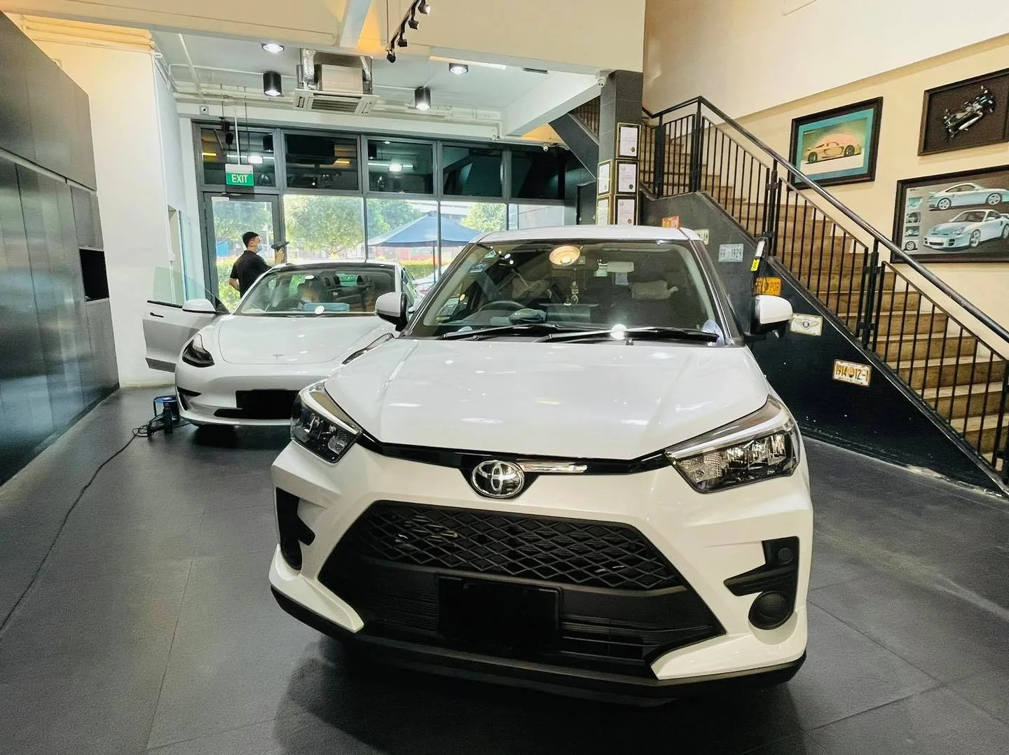 White Toyota Raize crossover inside the Infratint Singapore showroom