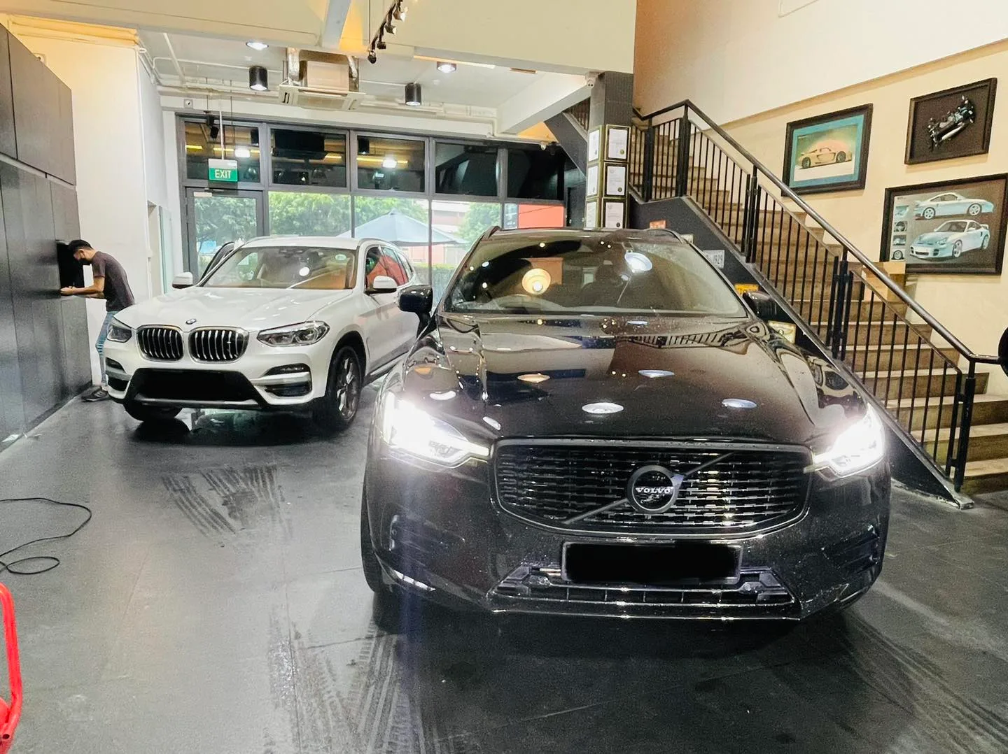 Black Volvo SUV and white BMW X3 at Infratint Singapore for window film