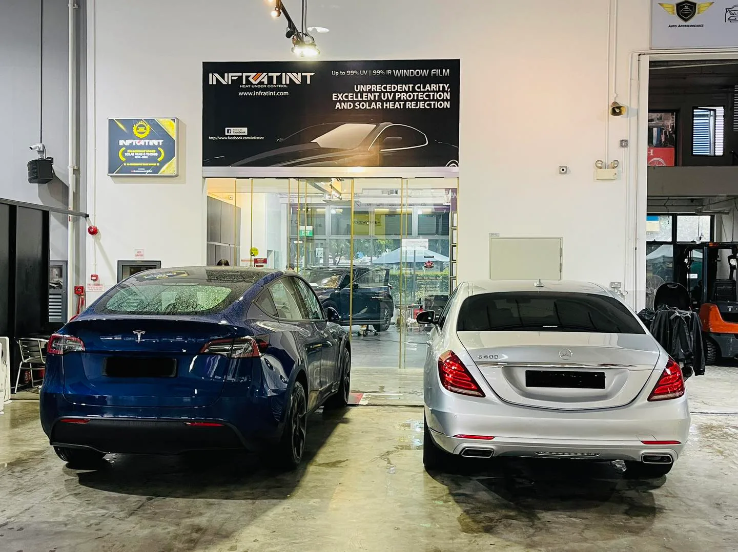Blue Tesla and silver Mercedes-Benz S-Class at Infratint Singapore for solar film