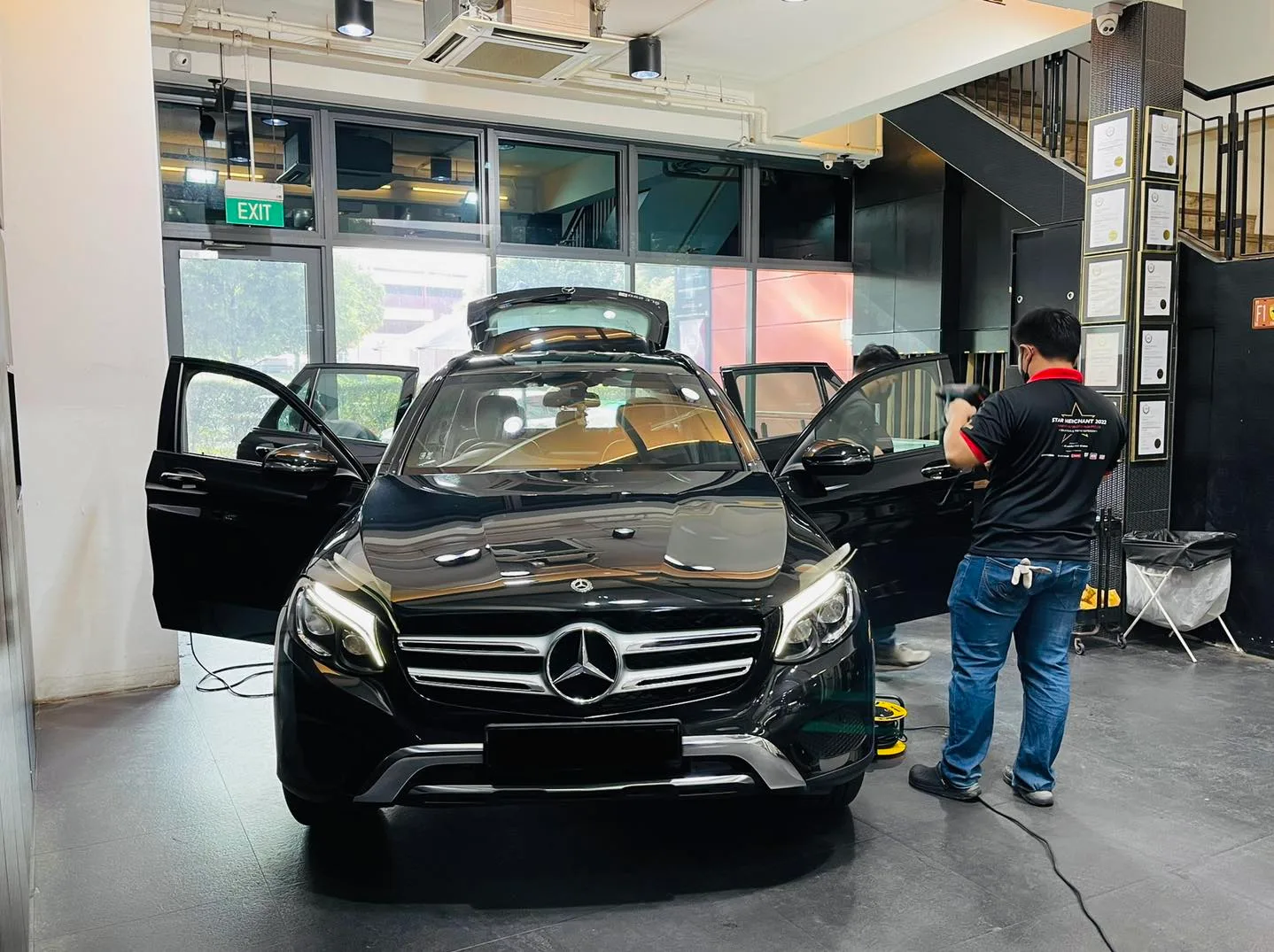 Black Mercedes-Benz GLC with doors open during window tinting at Infratint Singapore