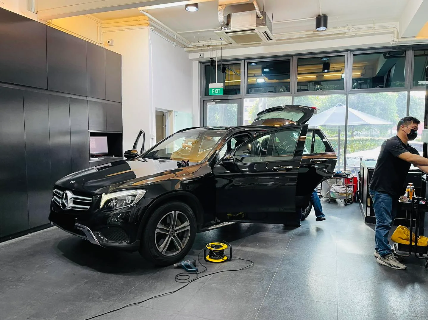 Black Mercedes-Benz GLC with tailgate open during window film install at Infratint Singapore