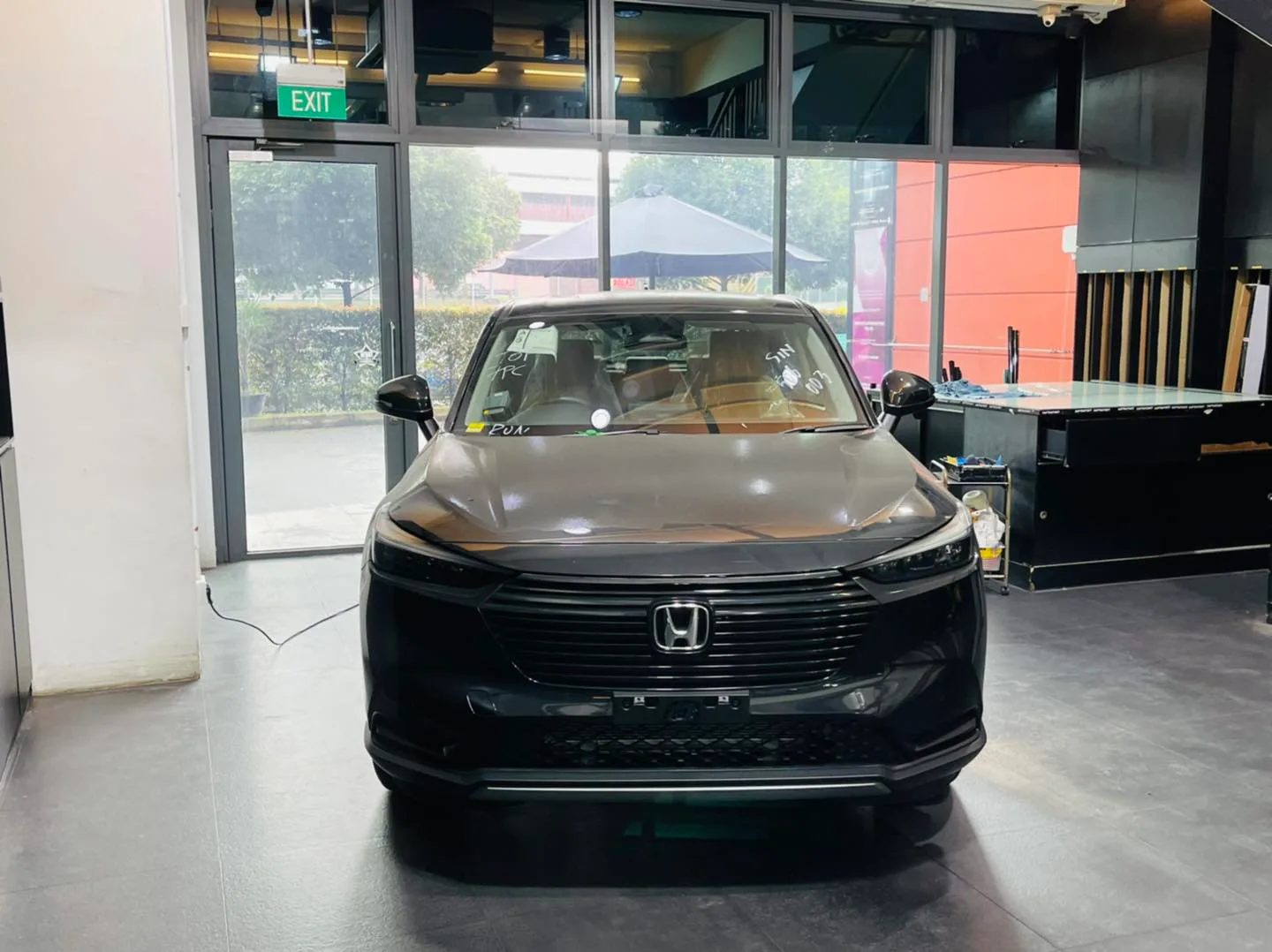 Grey Honda crossover with marked windscreen awaiting window film at Infratint Singapore