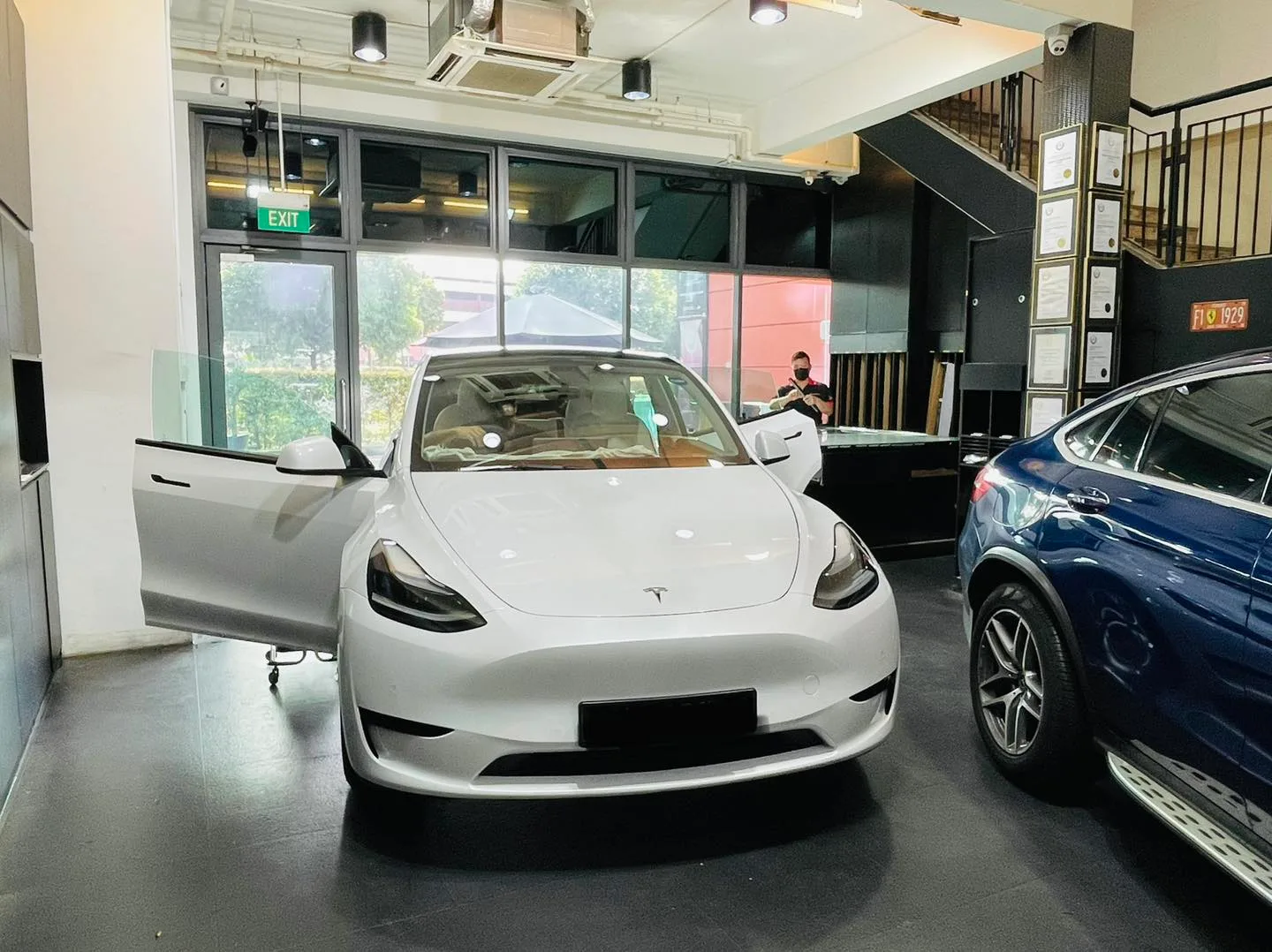 White Tesla Model Y getting window tinting at Infratint Singapore