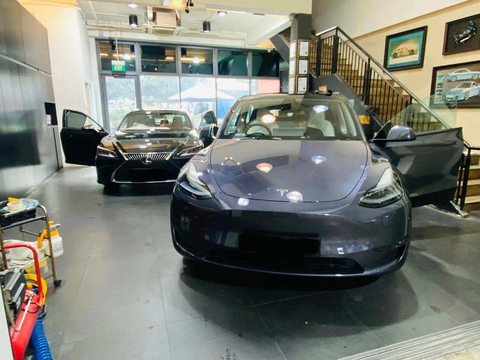Grey Tesla Model Y and black Lexus ES inside the Infratint Singapore showroom