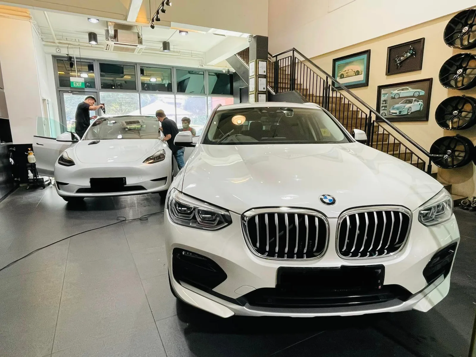 White BMW X4 and white Tesla Model Y at Infratint Singapore for window film