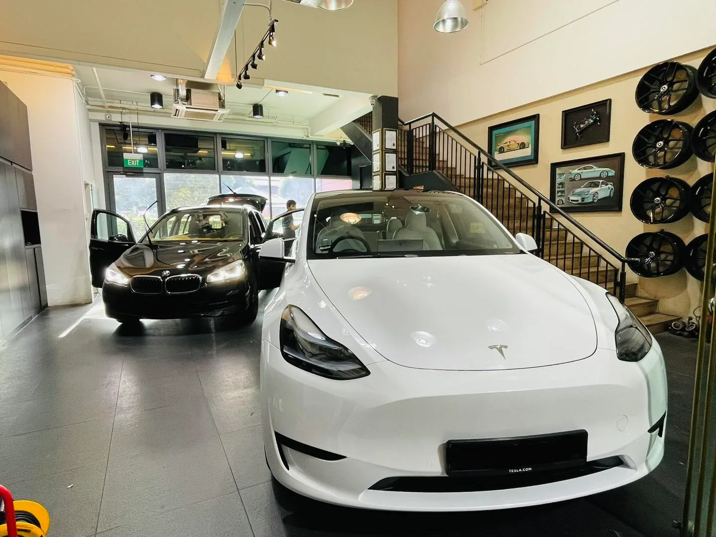 White Tesla Model Y and black BMW at Infratint Singapore for window tinting