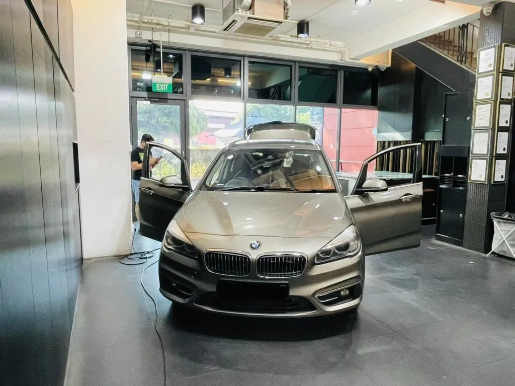 Champagne BMW 2 Series Active Tourer with doors open at Infratint Singapore
