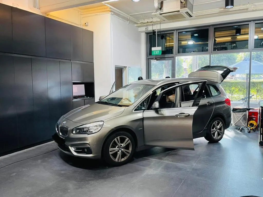 Champagne BMW 2 Series Active Tourer side view with tailgate open during tinting