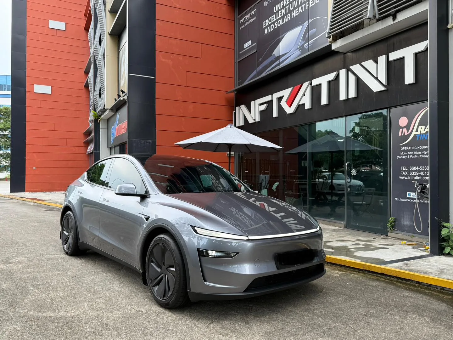 Silver Tesla Model Y Juniper front three-quarter view outside Infratint Singapore