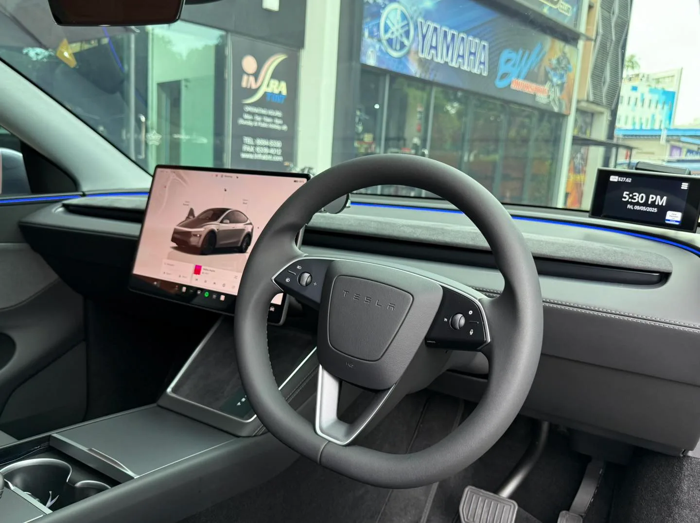 Tesla Model Y Juniper interior, steering wheel and touchscreen through tinted glass at Infratint Singapore