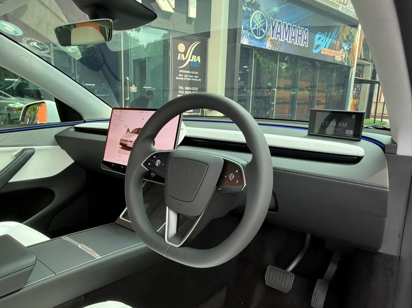 Tesla Model Y Juniper interior and touchscreen seen through tinted glass at Infratint Singapore
