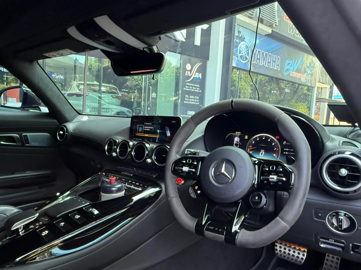 Mercedes-AMG GT R interior and steering wheel seen through tinted glass at Infratint Singapore