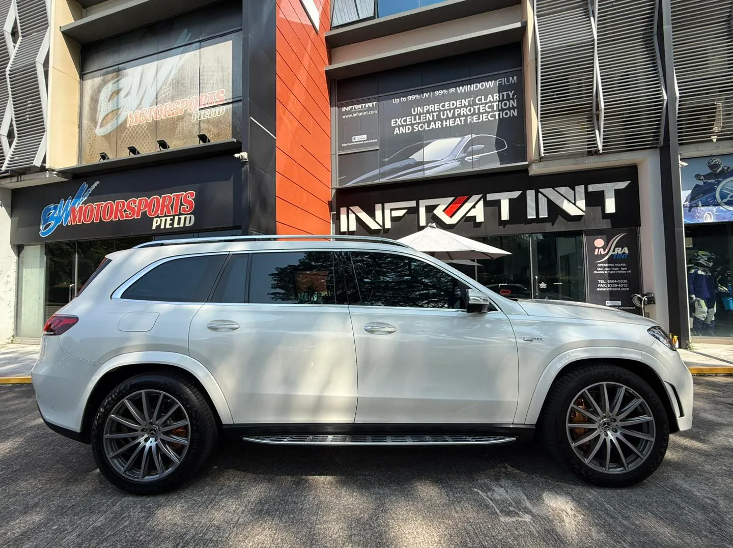 White Mercedes-Benz GLS side profile with tinted windows outside Infratint Singapore