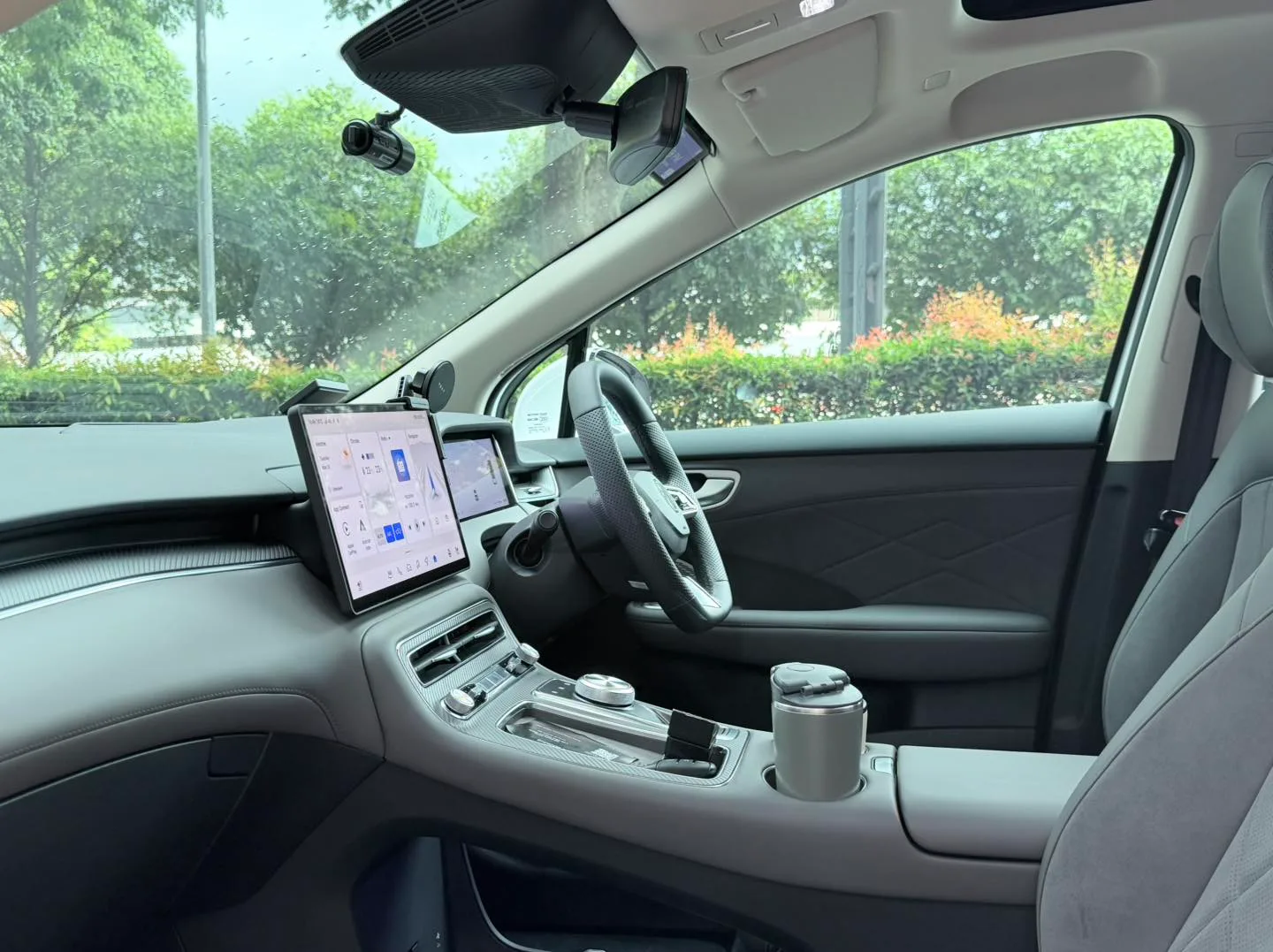 MG S6 EV light grey interior and touchscreen seen through tinted glass at Infratint Singapore