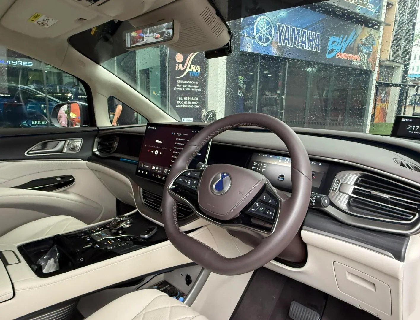 Denza cream leather interior and dashboard seen through tinted windscreen at Infratint Singapore
