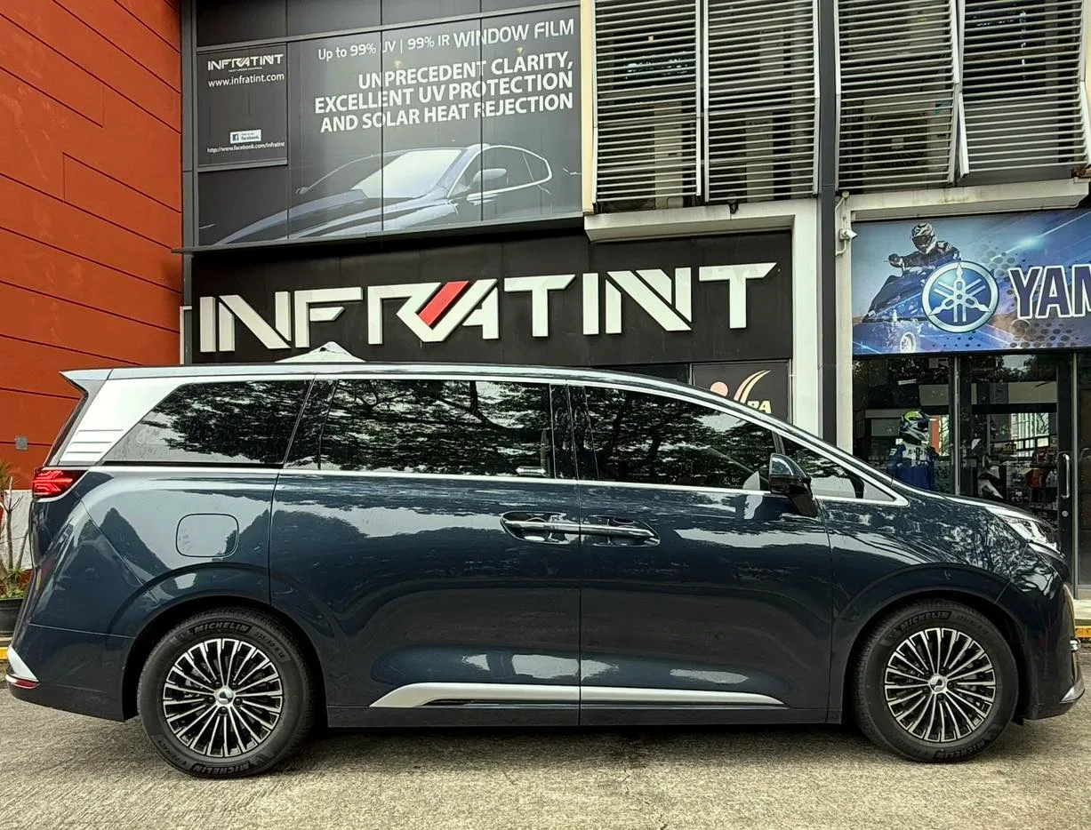 Dark blue Denza luxury MPV side profile with tinted windows at Infratint Singapore