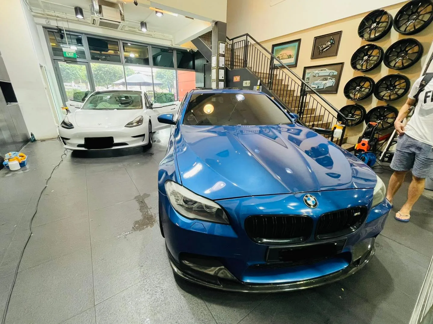 Blue BMW 5 Series and white Tesla Model 3 at Infratint Singapore for window tinting