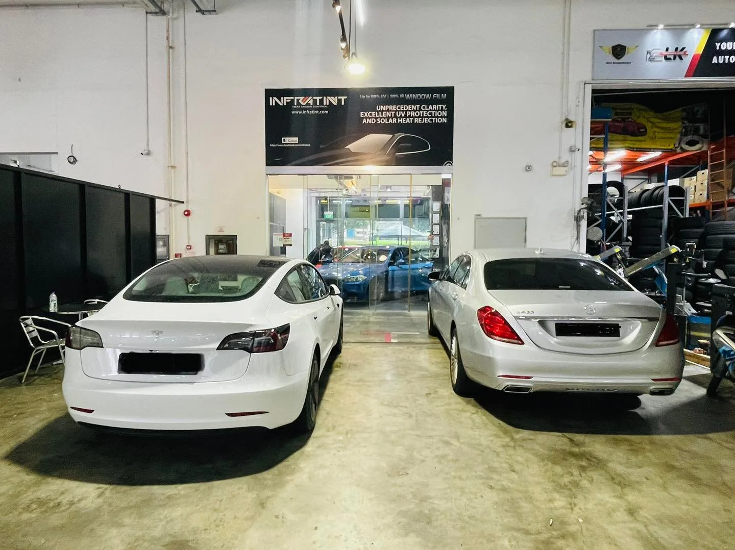 White Tesla Model 3 and silver Mercedes-Benz S-Class at Infratint Singapore