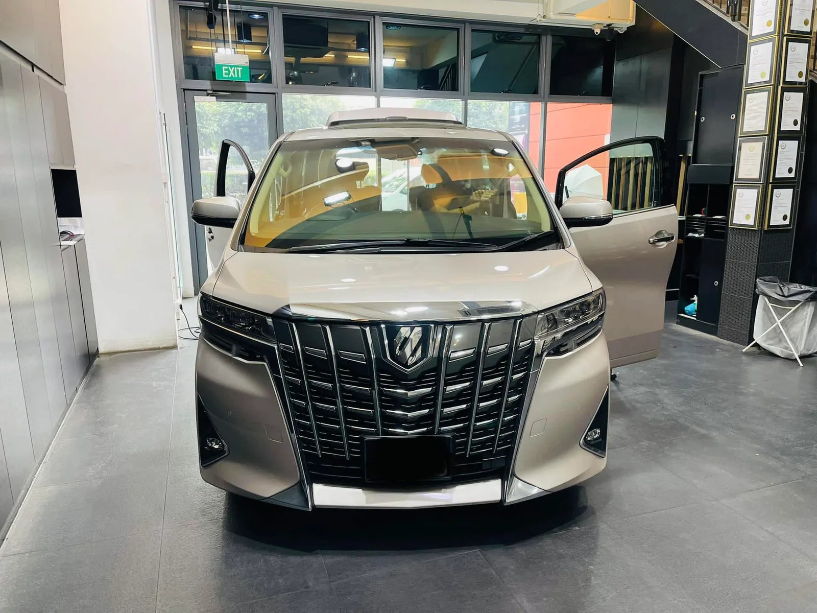 Champagne gold Toyota Alphard viewed head-on at Infratint Singapore for window film