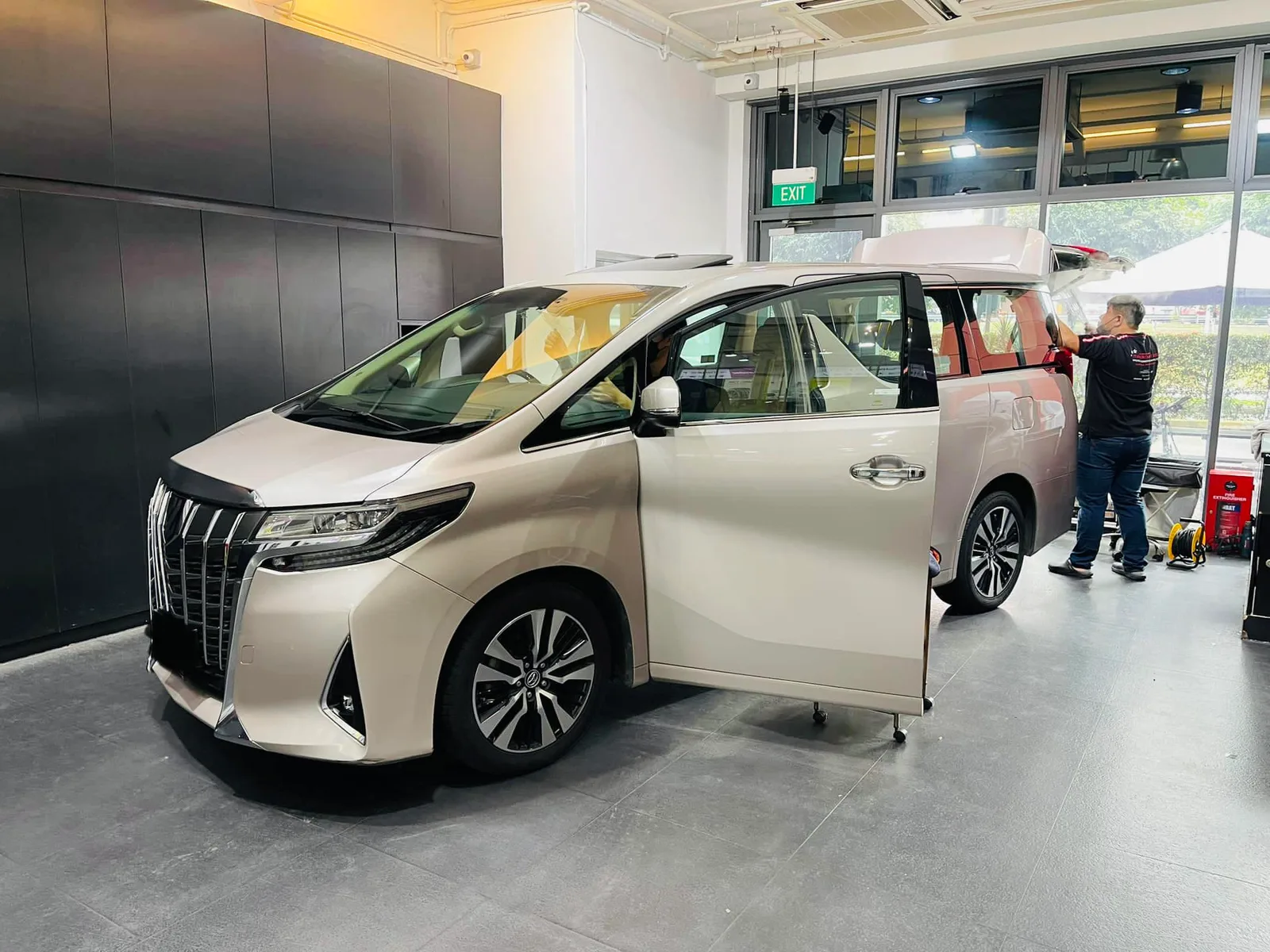 Champagne Toyota Alphard side profile during window tinting at Infratint Singapore