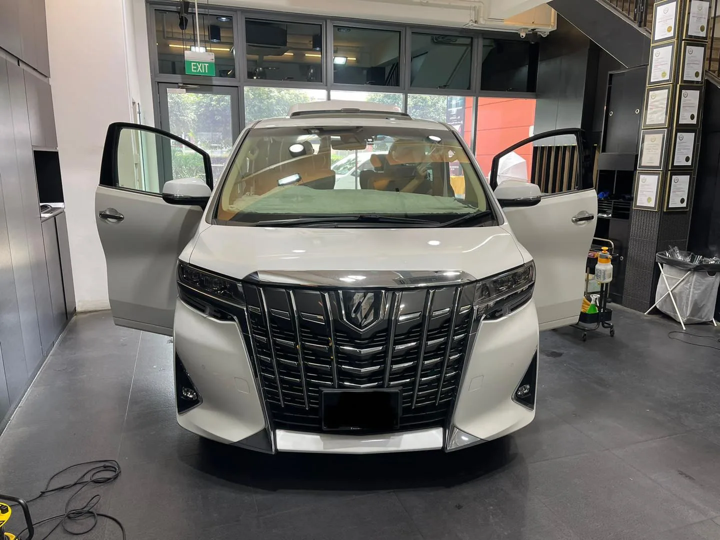 White Toyota Alphard with front doors open at Infratint Singapore for window tinting