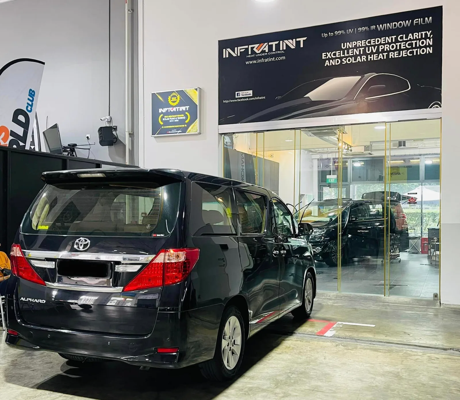 Black Toyota Alphard rear view under the Infratint banner at Infratint Singapore