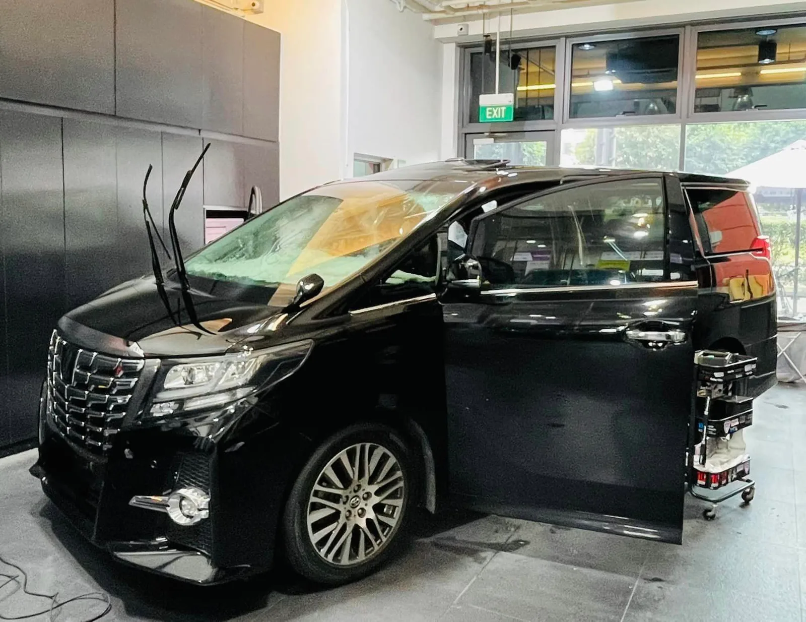 Black Toyota Alphard side profile during windscreen tinting at Infratint Singapore