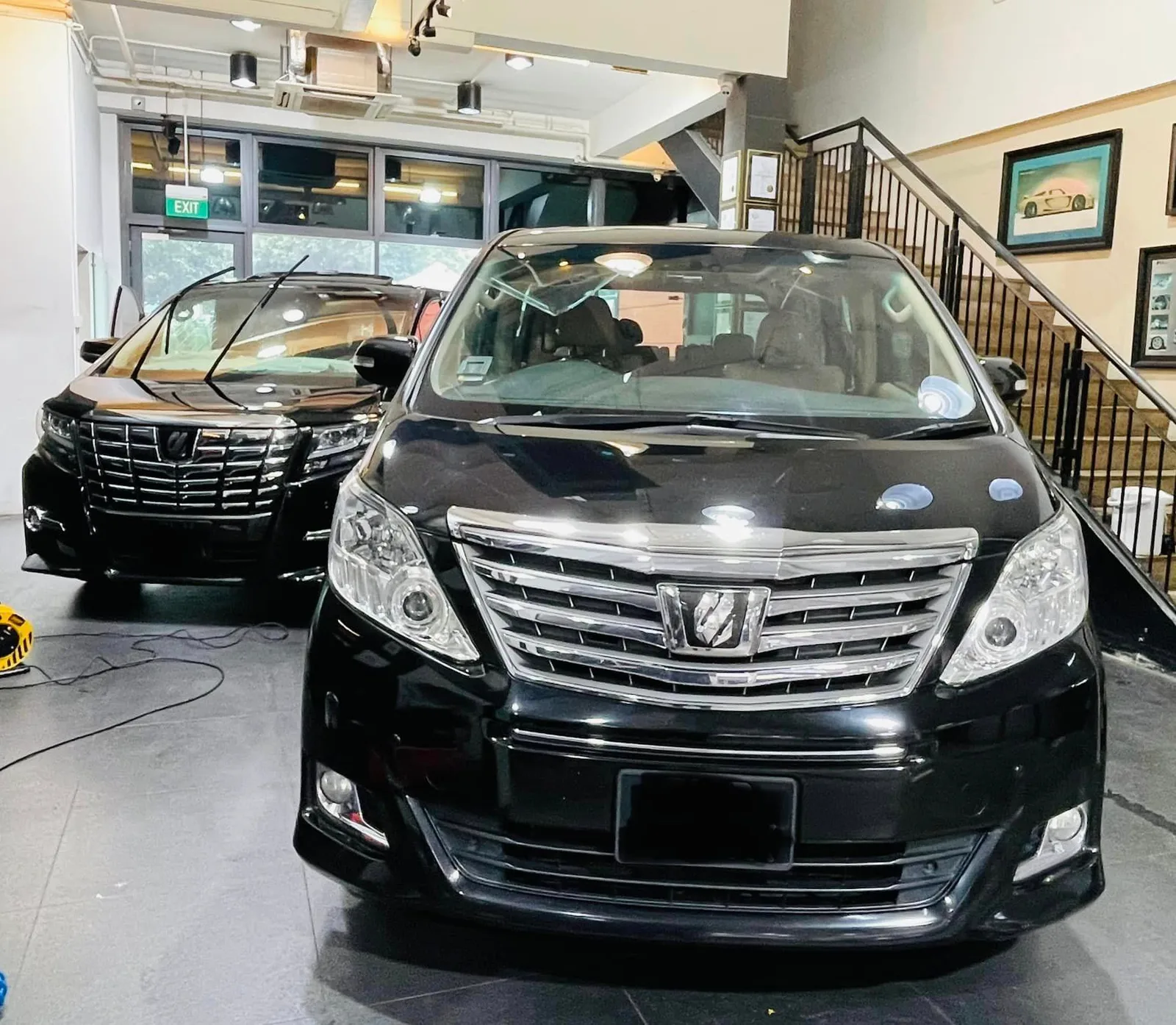 Two black Toyota Alphard MPVs front view in the showroom at Infratint Singapore