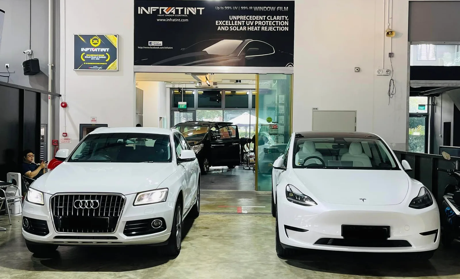 White Audi Q5 and white Tesla Model Y in the install bay at Infratint Singapore