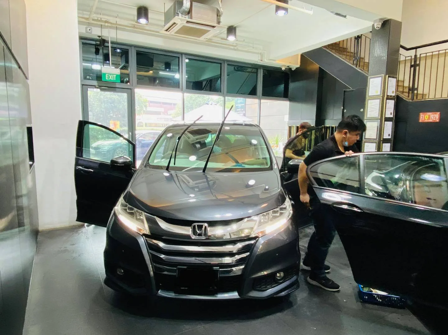 Grey Honda Odyssey with doors open being tinted at Infratint Singapore