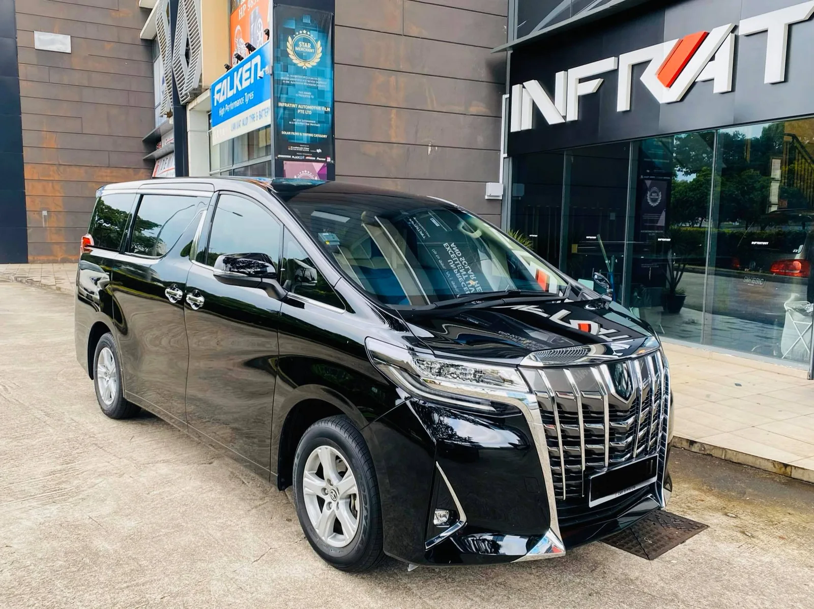 Black Toyota Alphard parked outside the Infratint Singapore shopfront after tinting