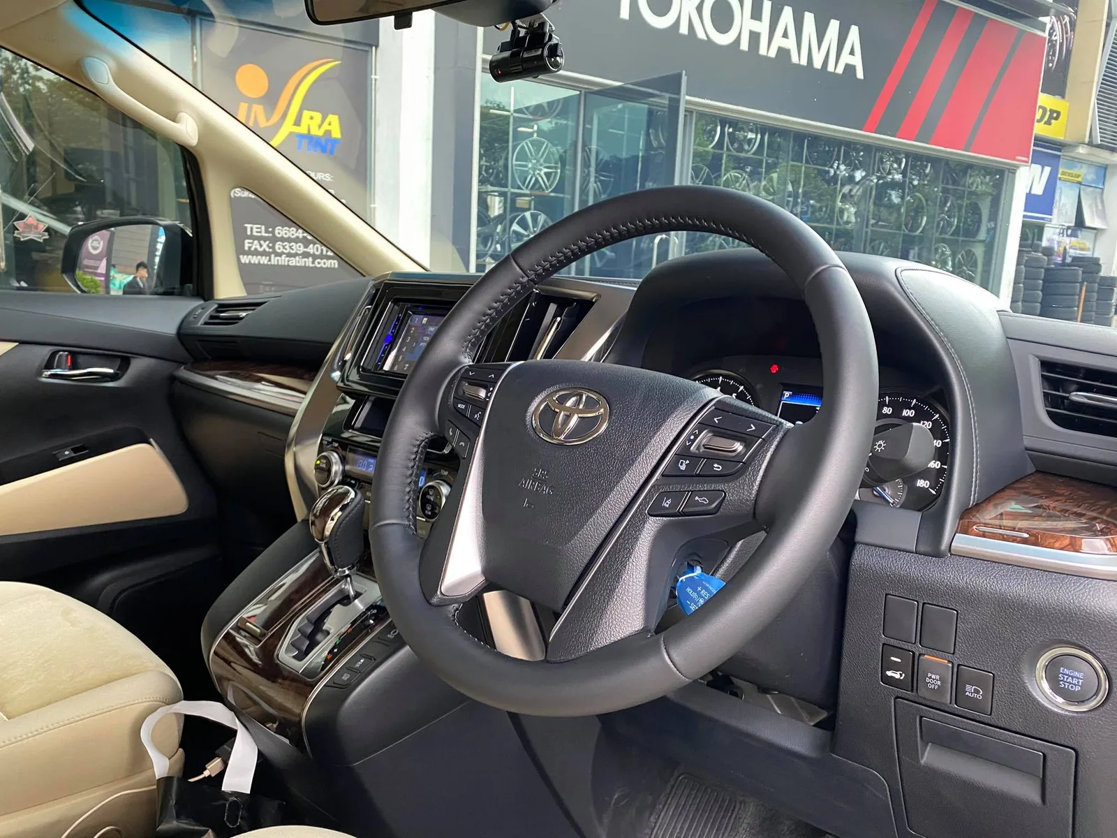Interior dashboard and steering wheel of a Toyota Alphard at Infratint Singapore