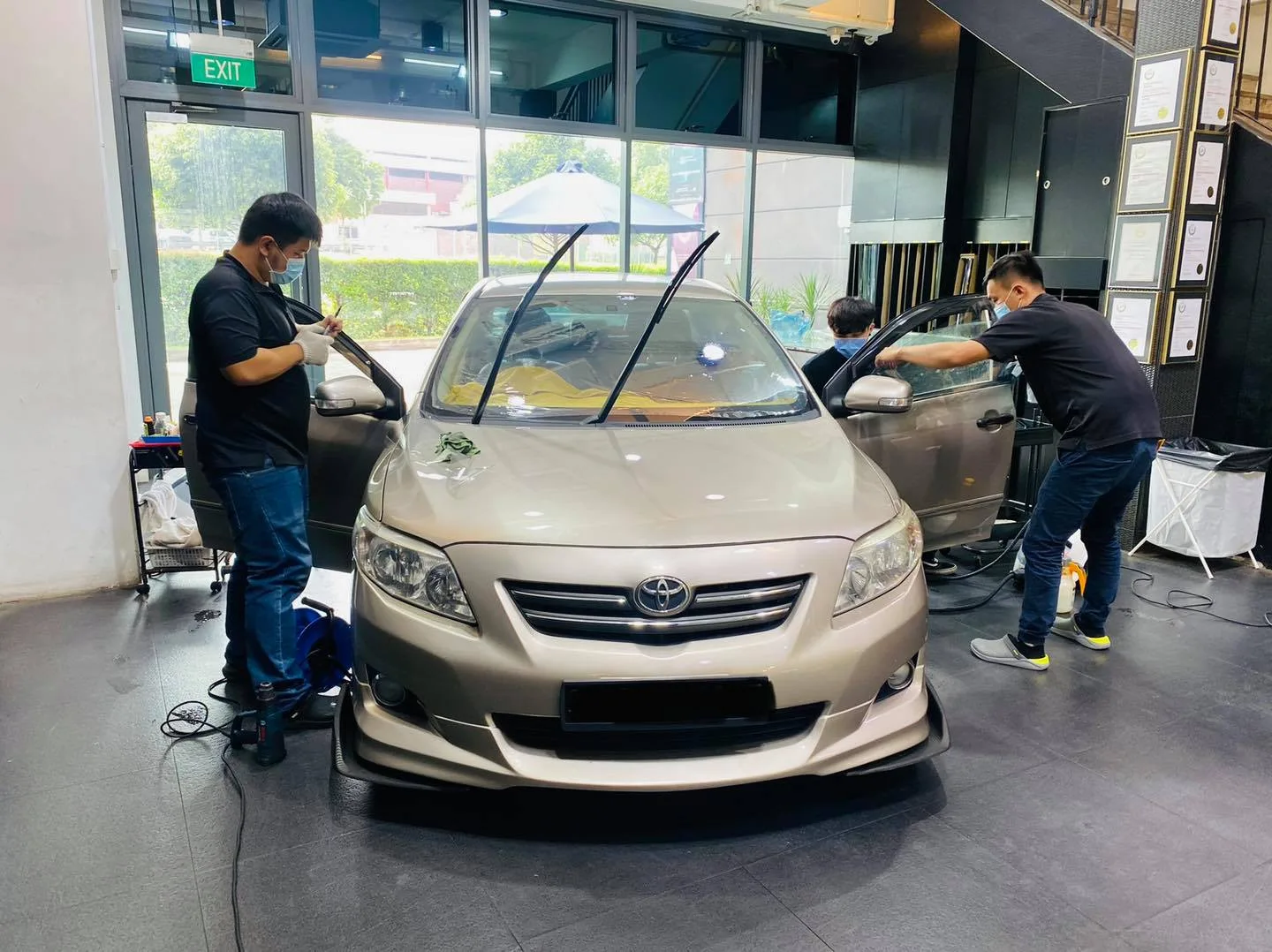 Champagne Toyota Corolla Altis windscreen being tinted at Infratint Singapore