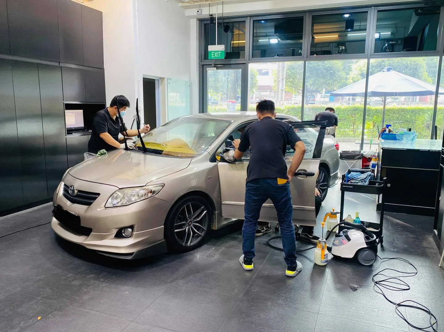 Champagne Toyota Corolla Altis side glass being tinted at Infratint Singapore
