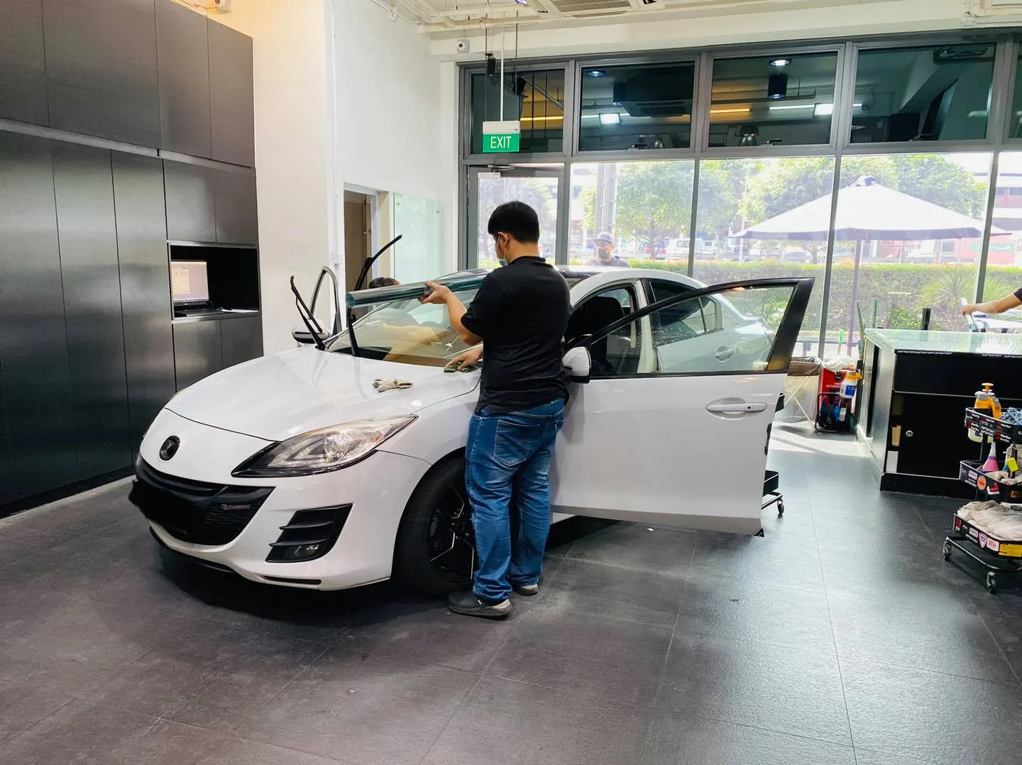 White Mazda 3 side window being tinted at Infratint Singapore