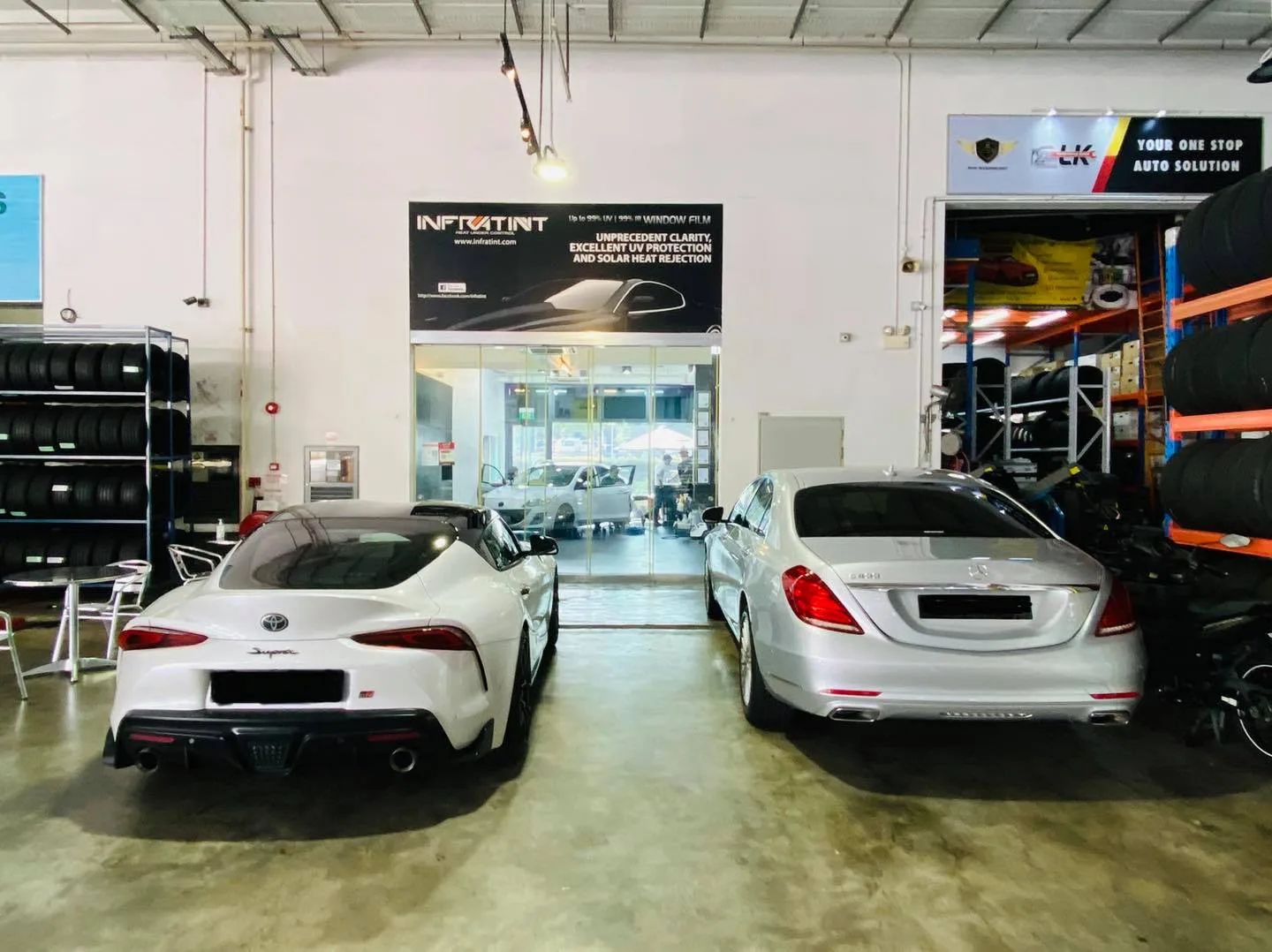 White Toyota Supra and silver Mercedes-Benz S-Class in the workshop at Infratint Singapore