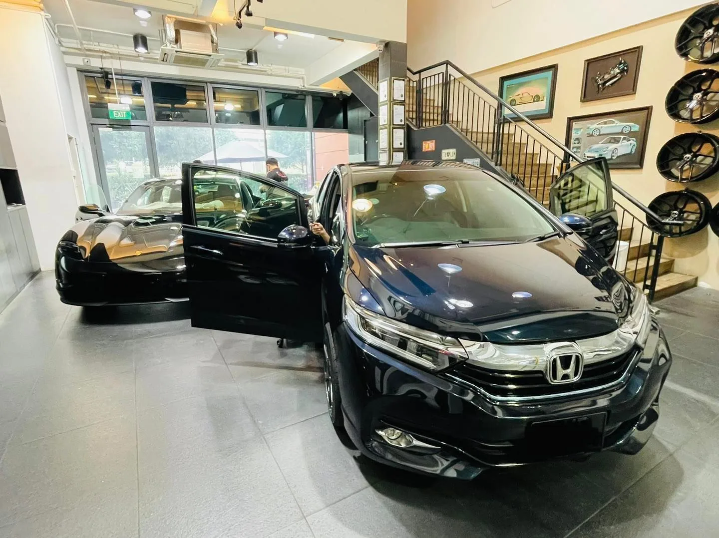 Black Honda hatch with door open inside the Infratint Singapore showroom for window film