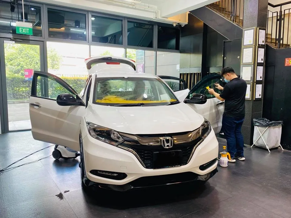 White Honda HR-V SUV getting window film applied to the front side glass at Infratint Singapore
