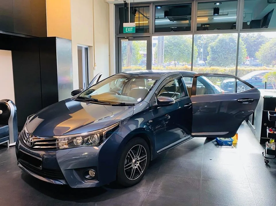 Blue-grey Toyota Altis sedan prepped for window tinting at Infratint Singapore